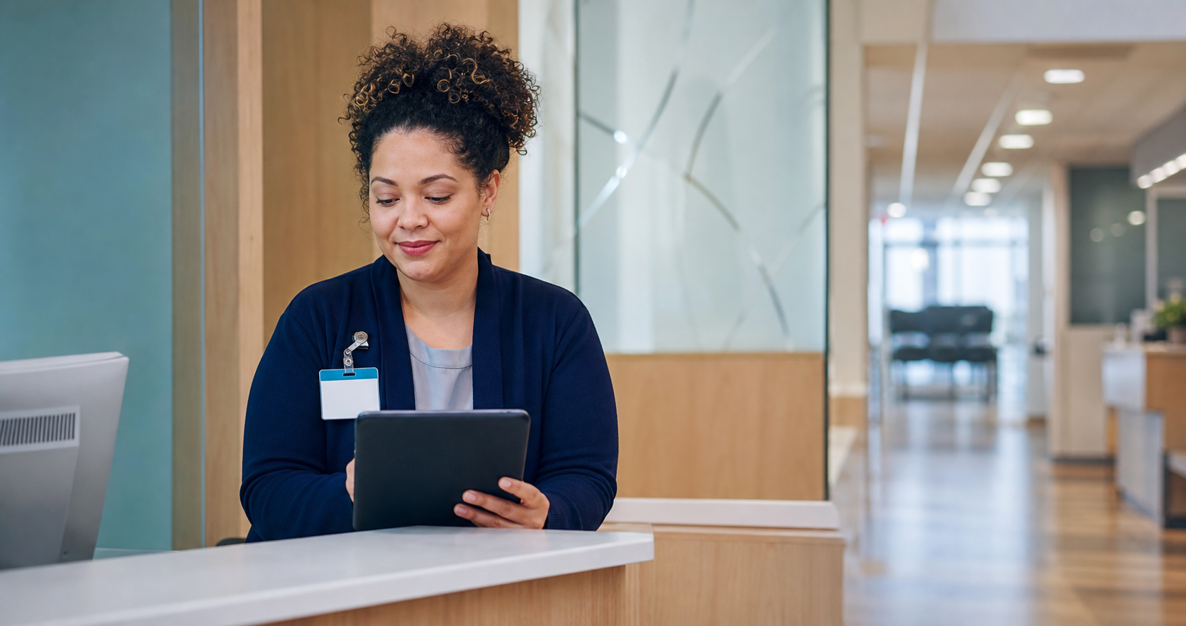 Patient access coordinator working at a hospital reception desk